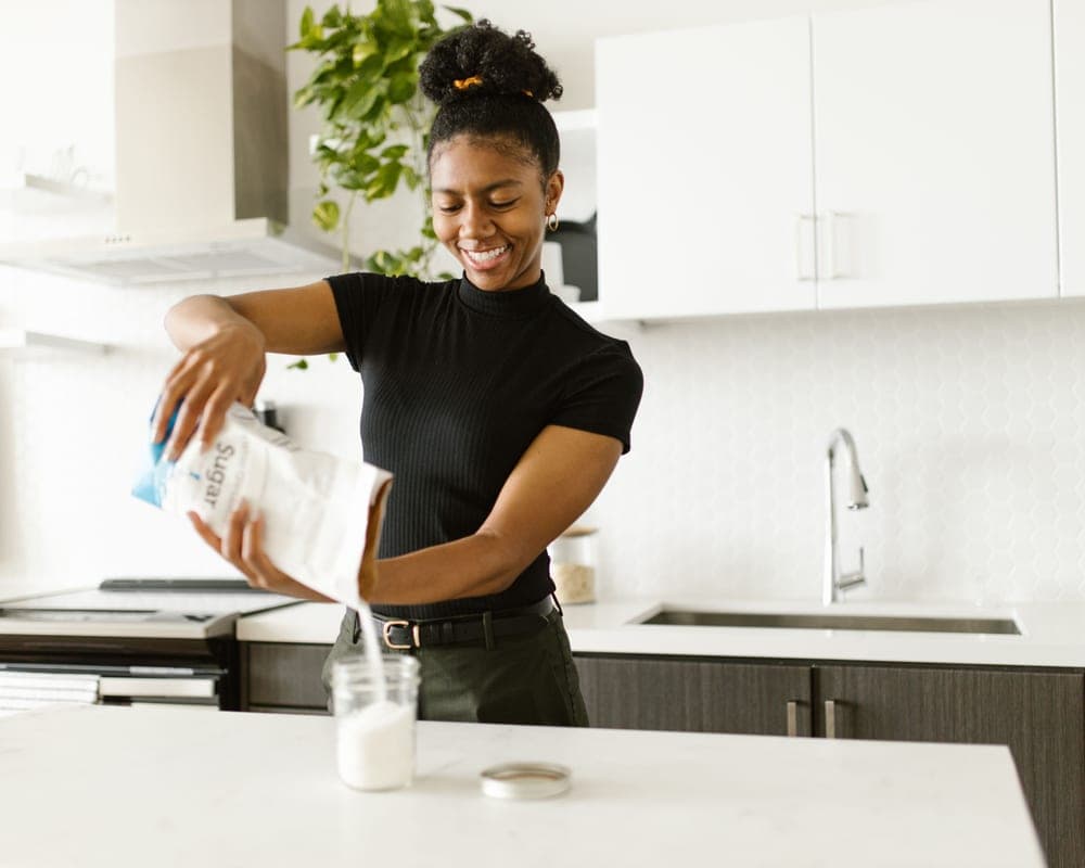 A kitchen counter being wiped down during a home clean