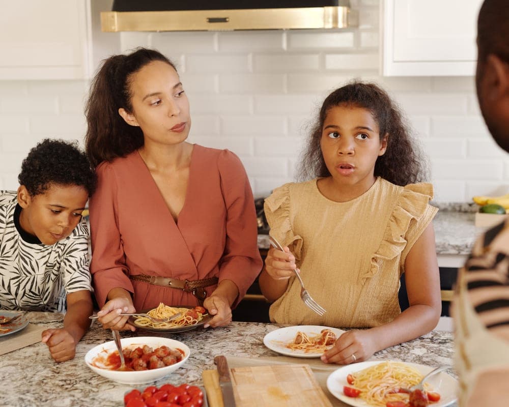 A family spending time together in a clean, bright kitchen